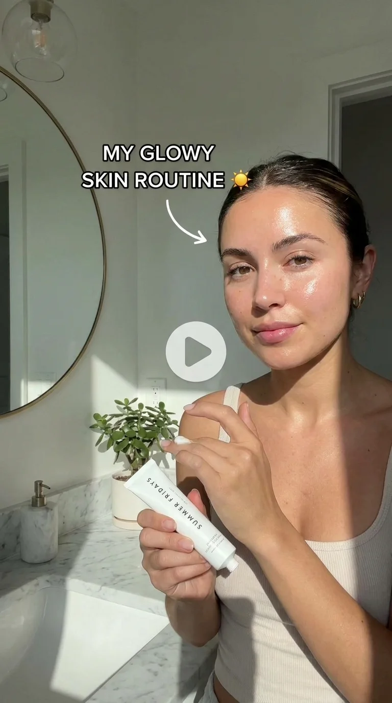 Close-up of glowing skin with luxury serum application, bright airy lighting, marble bathroom